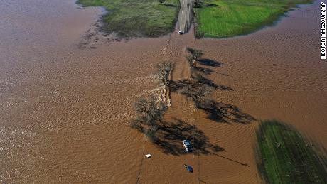 Three vehicles are submerged on Dillard Road west of Highway 99 in south Sacramento County in Wilton, Calif., Sunday, Jan. 1, 2023, after heavy rains on New Year's Eve produced levee breaks. 