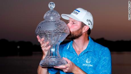 Chris Kirk kisses the trophy after winning the Honda Classic golf tournament in a playoff against Eric Cole, Sunday, Feb. 26, 2023, in Palm Beach Gardens, Fla. (AP Photo/Lynne Sladky)