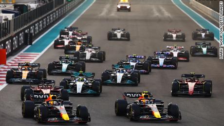 ABU DHABI, UNITED ARAB EMIRATES - NOVEMBER 20: Max Verstappen of the Netherlands driving the (1) Oracle Red Bull Racing RB18 and Sergio Perez of Mexico driving the (11) Oracle Red Bull Racing RB18 lead the field into turn one at the start during the F1 Grand Prix of Abu Dhabi at Yas Marina Circuit on November 20, 2022 in Abu Dhabi, United Arab Emirates. 