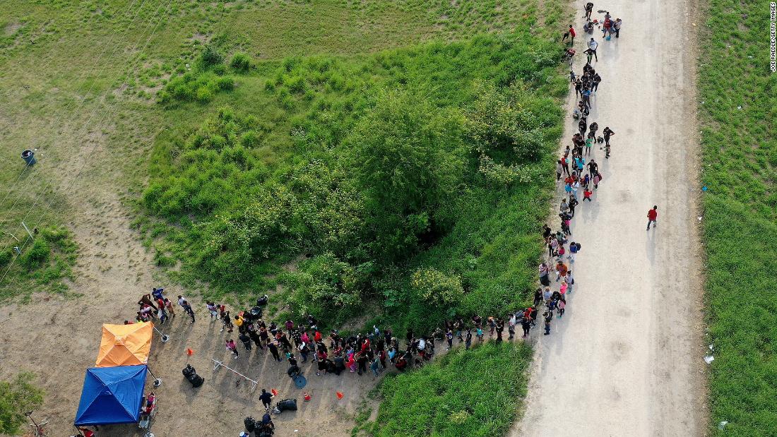 Migrants stand in line as they wait to be processed by US Border Patrol agents in Brownsville on May 10.