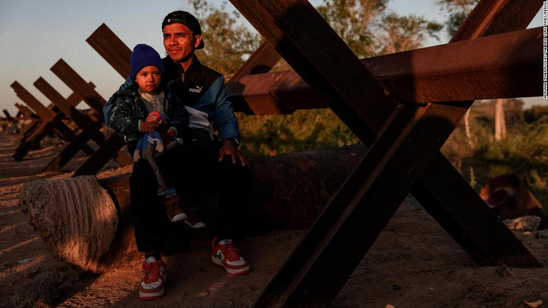 Erick Torres and his son Benjamin, migrants from Peru, wait to be processed by US Border Patrol agents in Yuma on May 11.
