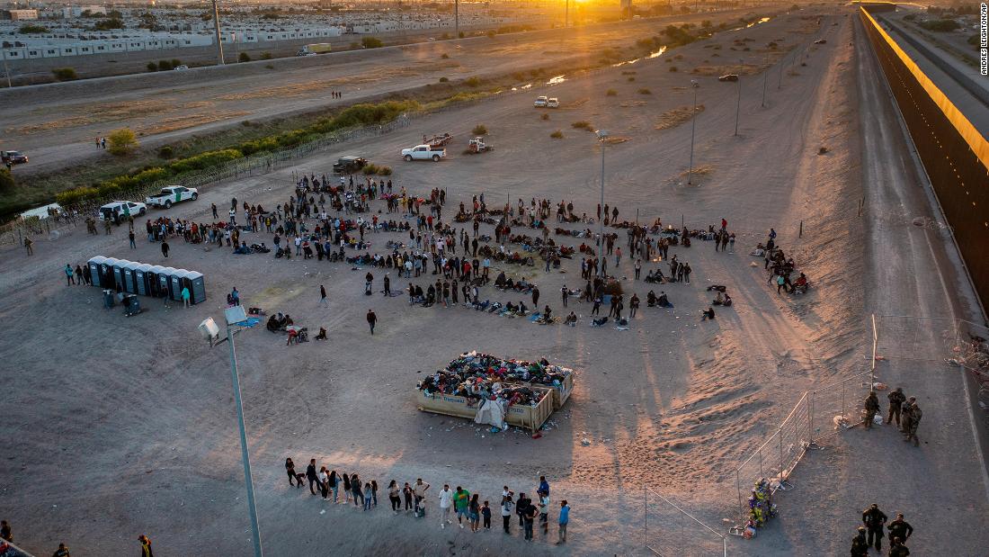 As the sun sets on May 11, migrants wait to be processed by US Border Patrol agents across the border from El Paso.