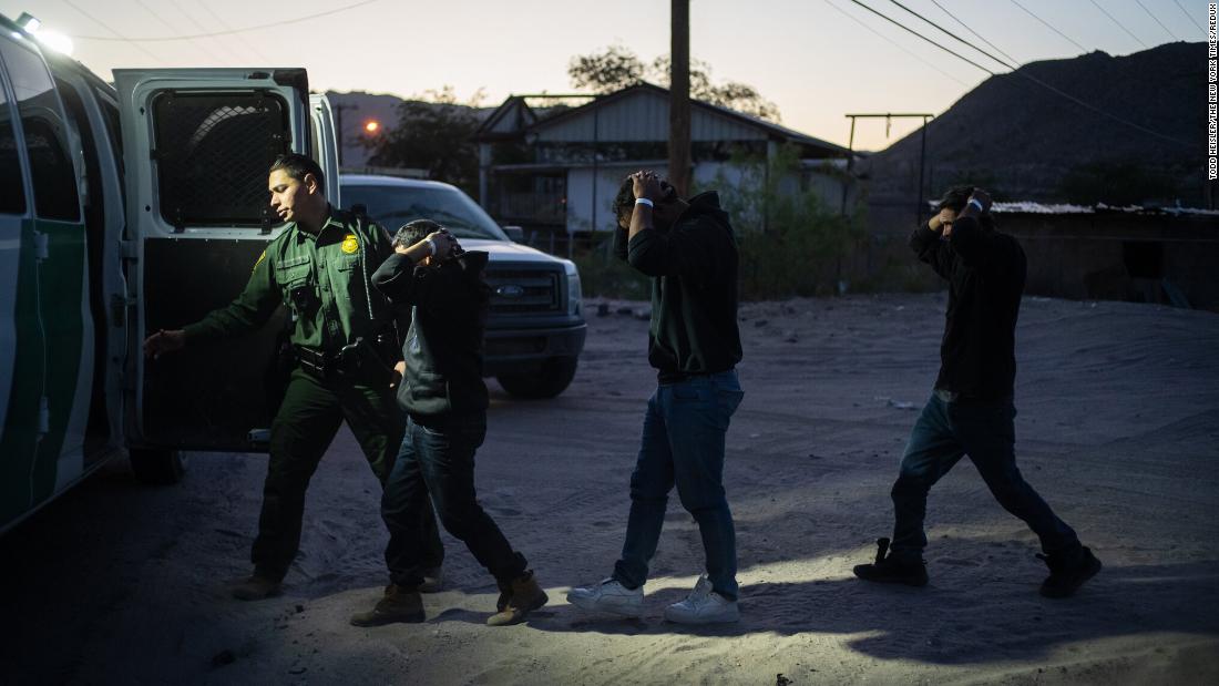 A group of men from El Salvador are detained by US Border Patrol agents after crossing from Mexico near Sunland Park, New Mexico, on Friday, May 12.