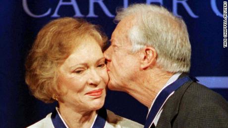 Former President Jimmy Carter (R) kisses former first lady Rosalynn Carter on the cheek after they received the Presidential Medal of Freedom, the nations&#39; highest honor, from President Bill Clinton during a ceremony at the Carter Center in Atlanta, August 9. The Carters were presented with the medals for the work they have done since leaving the White House in 1980.