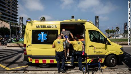 Paramedics help a patient into an ambulance during a heat wave in Barcelona, Spain, on Monday, July 18, 2022. 