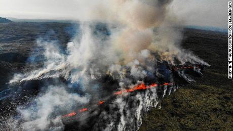 This aerial photograph taken on July 10, 2023 shows smoke billowing from flowing lava during an volcanic eruption near Litli Hrutur, south-west of Reykjavik in Iceland. A volcanic eruption started on July 10, 2023 around 30 kilometres (19 miles) from Iceland&#39;s capital Reykjavik, the country&#39;s meteorological office said, marking the third time in two years that lava has gushed out in the area. &quot;The eruption is taking place in a small depression just north of Litli Hrutur, from which smoke is escaping in a north-westerly direction,&quot; the office said. Footage circulating in the local media shows a massive cloud of smoke rising from the ground as well as a substantial flow of lava. (Photo by Kristinn Magnusson / AFP) / Iceland OUT (Photo by KRISTINN MAGNUSSON/AFP via Getty Images)