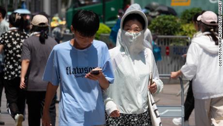 SHANGHAI, CHINA - JULY 11, 2023 - Tourists travel in high temperatures in Shanghai, China, July 11, 2023. (Photo by Costfoto/NurPhoto via Getty Images)