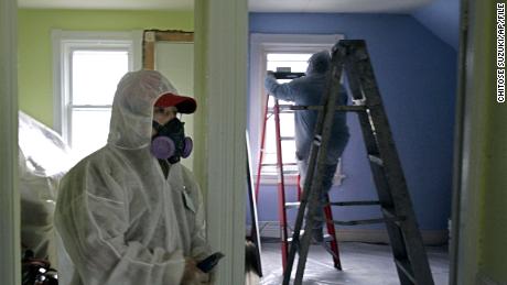 ** FILE ** In this Feb. 23, 2006 file photo, contractors Luis Benitez, foreground, and Jose Diaz, background, clean up lead paint at a contaminated building in Providence, R.I.   As of Thursday, contractors across the country will have to take additional precautions when renovating houses where children could be exposed to harmful lead dust from old paint, which could add thousands of dollars to renovation projects and cripple an industry already reeling from the recession. (AP Photo/Chitose Suzuki)