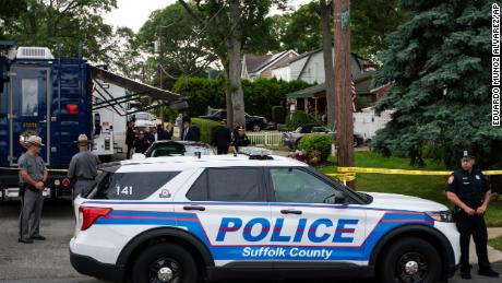 Law enforcement arrive to a house Friday, July 14, 2023, as sources said a suspect has been taken into custody in connection with a long-unsolved string of killings on New York&#39;s Long Island.