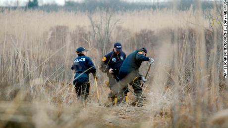 FILE - Crime scene investigators use metal detectors to search a marsh for the remains of Shannan Gilbert, Dec. 12, 2011 in Oak Beach, New York. A Long Island architect has been charged, Friday, July 14, 2023, with murder in the deaths of three of the 11 victims in a long-unsolved string of killings known as the Gilgo Beach murders. (James Carbone/Newsday via AP, Pool, File) 