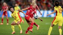 China's Zhang Linyan competes for the ball with Denmark's Pernille Harder.