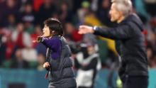 China head coach Shui Qingxia gestures during the match.
