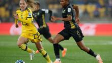 South Africa's Hildah Magaia, who scored the opening goal, runs with the ball alongside Sweden's Elin Rubensson.