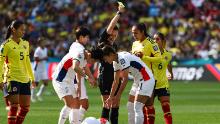 Colombia midfielder Manuela Vanegas receives a yellow card from referee Rebecca Welch.