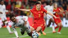 Haiti's Melchie Dumornay, left, collides with China's Dou Jiaxing on July 28.