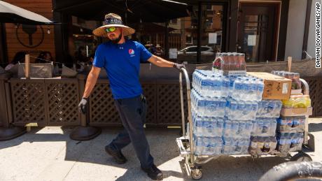 Driver Jose Viveros delivers bottled water and other beverages in the Little Tokyo district of Los Angeles on Thursday.