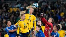 Sweden's Amanda Ilestedt, center, heads the ball to score the opening goal against Italy on July 29. Sweden won 5-0.