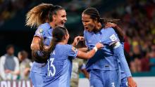 France's Wendie Renard, right, celebrates with teammates after scoring her team's second goal.