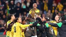 Jamaica players celebrate after Allyson Swaby scores the team's first goal.
