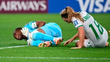 Nigeria's Chiamaka Nnadozie and Ireland's Kyra Carusa react after a collision.