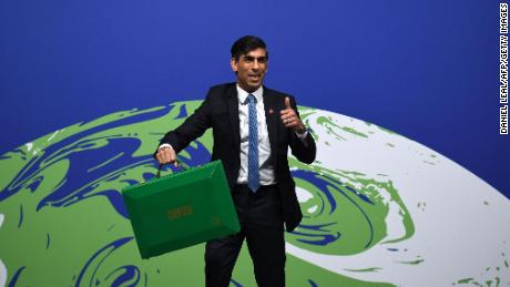 Britain&#39;s Chancellor of the Exchequer Rishi Sunak poses with a green briefcase similar to the red Budget Box before opening Finance Day at the COP26 UN Climate Summit in Glasgow on November 3, 2021. - Sunak is to announce plans to make Britain the world&#39;s first net zero financial services centre by 2050, the Treasury said. (Photo by Daniel LEAL / AFP) (Photo by DANIEL LEAL/AFP via Getty Images)