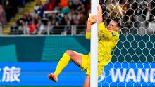 US goalkeeper Alyssa Naeher collides with the post.