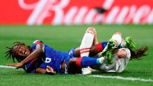 Haiti's Melchie Dumornay, left, gets tangled with Denmark's Simone Boye.