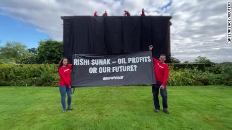 Greenpeace activists hung a black cloth over British Prime Minister Rishi Sunak&#39;s private mansion in northern England on Thursday, to protest a major oil and gas drilling expansion announced earlier this week.