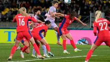 Japan's Mina Tanaka, center, rises for a header against Norway.
