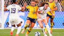 Sweden's Johanna Kaneryd, center, fights off Andi Sullivan.