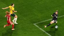 Foord scores a goal past Denmark goalkeeper Lene Christensen.