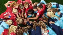 Denmark's players gather in a huddle before the match against Australia.