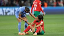 Morocco's Sakina Ouzraoui is consoled by France's Estelle Cascarino after the match.