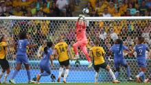 French goalkeeper Pauline Peyraud-Magnin punches the ball away during the quarterfinal match against Australia.