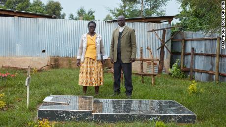 Agnes&#39; parents, Dinah and Vincent Tirop, visit their daughter&#39;s grave in the back of the family home in Nandi County. 