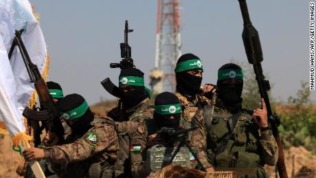 Palestinian fighters of the al-Qassam Brigades, the armed wing of the Hamas movement, take part in a military parade to mark the anniversary of the 2014 war with Israel, near the border in the central Gaza Strip on July 19, 2023. (Photo by MAHMUD HAMS / AFP) (Photo by MAHMUD HAMS/AFP via Getty Images)