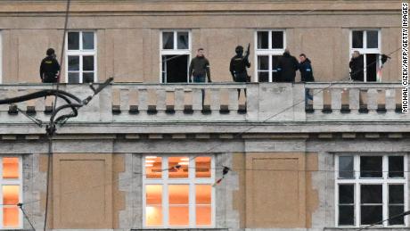 Armed police are seen on the balcony of the university in central Prague, on December 21, 2023. Czech police said Thursday a shooting in a university building in central Prague has left &quot;dead and wounded people&quot;, without providing further details.