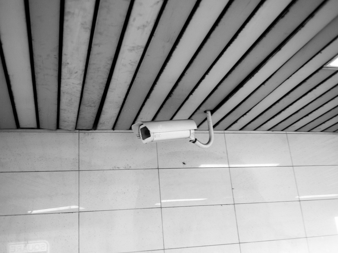A security camera watches a Metro station.