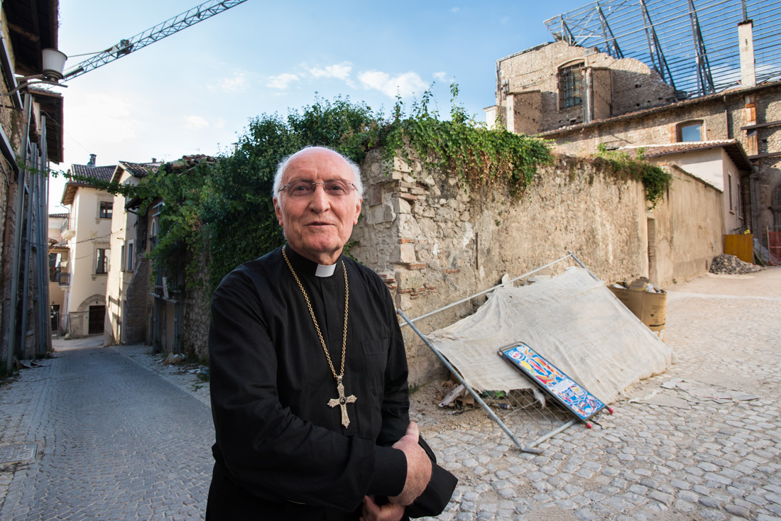 Monsignor Paolo De Nicolo tours the red zone. Visiting from Rome, he is set to perform Santa Messa, or 'Holy Mass,' at the Basilica Santa Maria di Collemaggio.