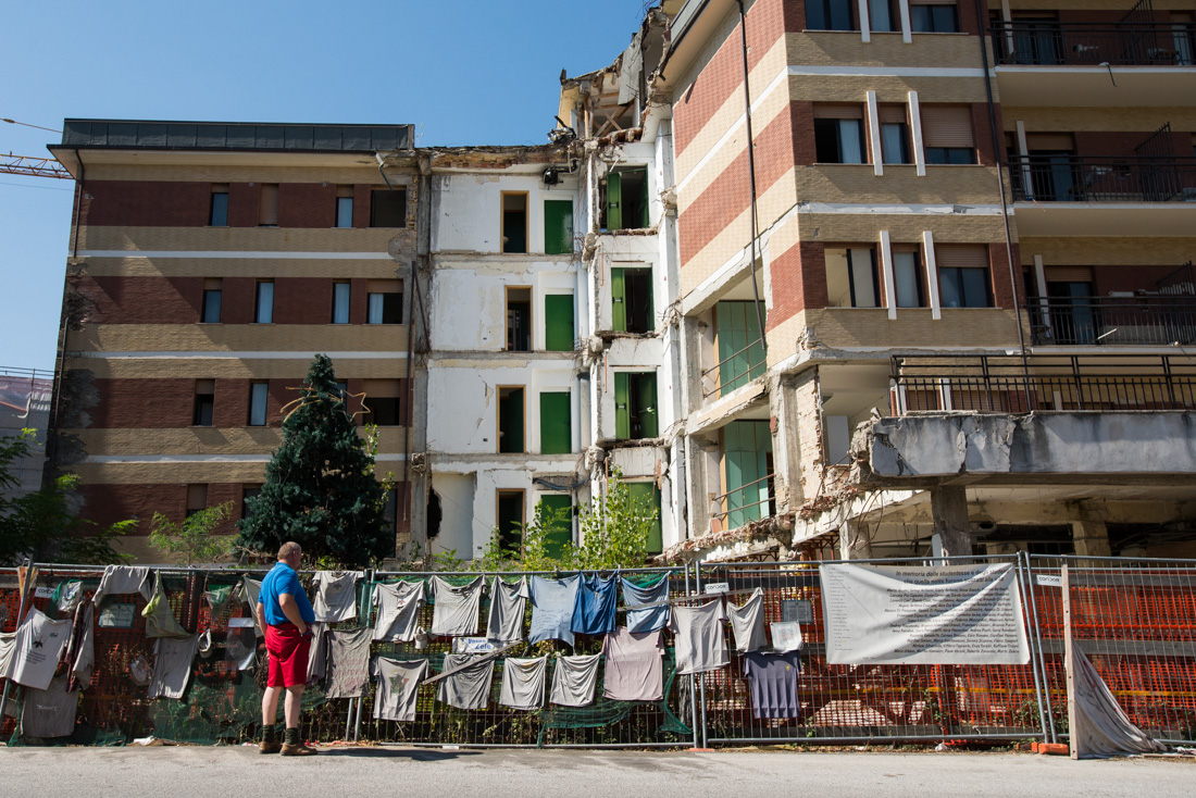 Giovanni Comoligio views a memorial for the 11 students who died in a university dormitory that collapsed during the earthquake.