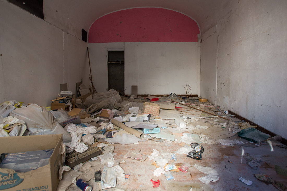 Litter fills an empty store in the red zone.