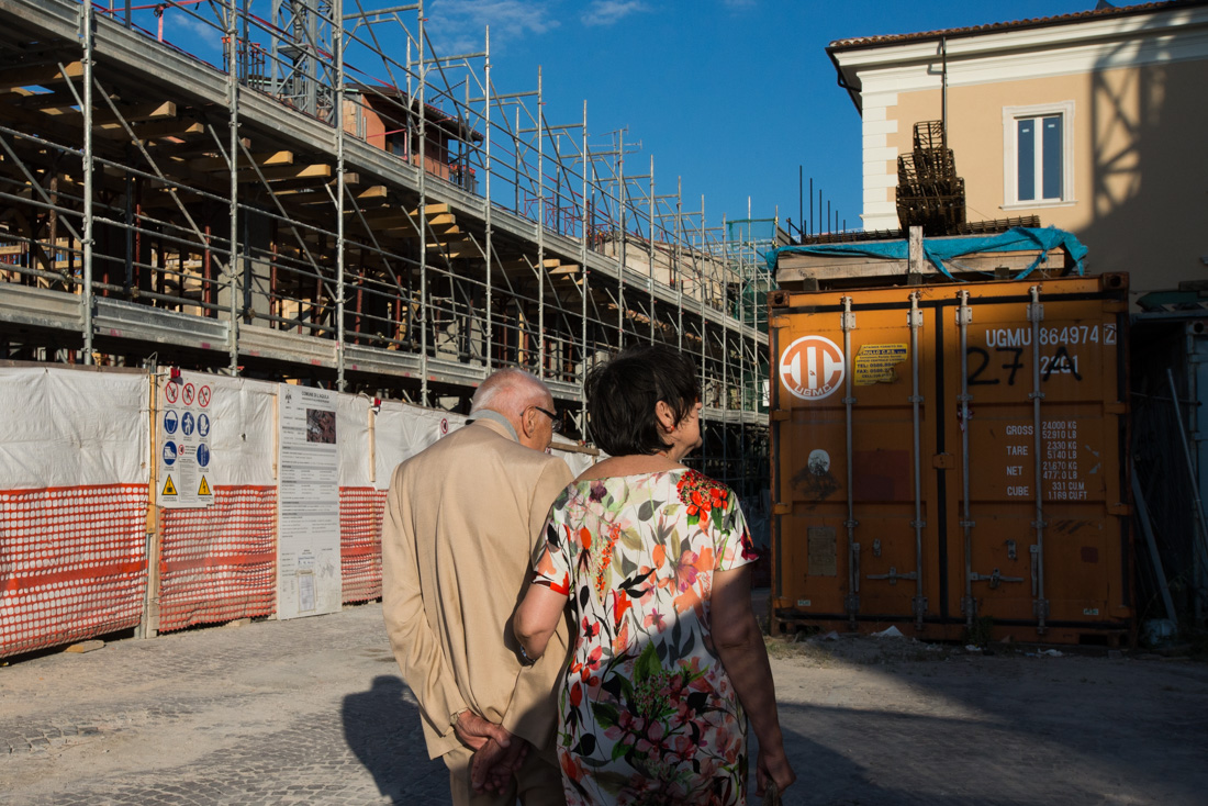 A man and woman take an evening stroll through the red zone.