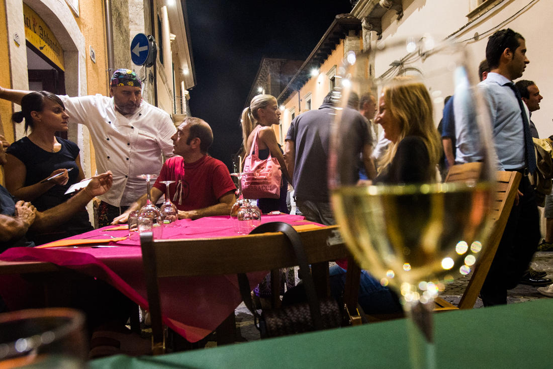 People dine al fresco on a Saturday night in L’Aquila.