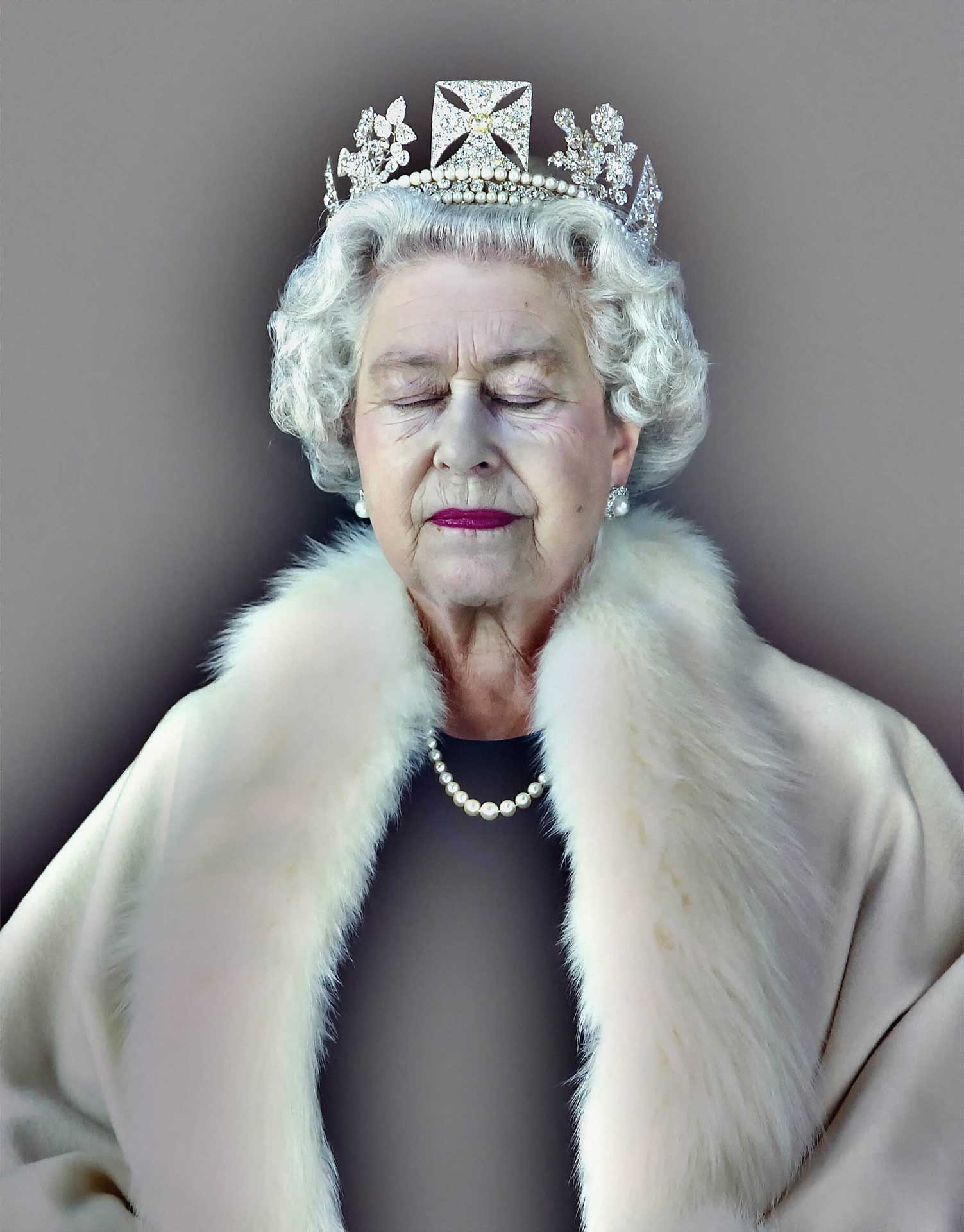 Queen Elizabeth II with her eyes shut wearing magenta lipstick, a diamond crown and a white ermine cap.