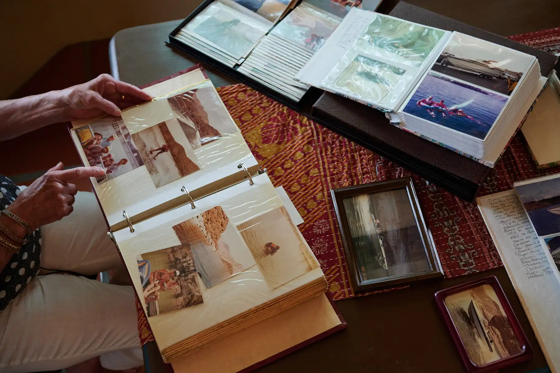 Dimeno flips through Browning's photo album of memories of his time at Lake Mead.