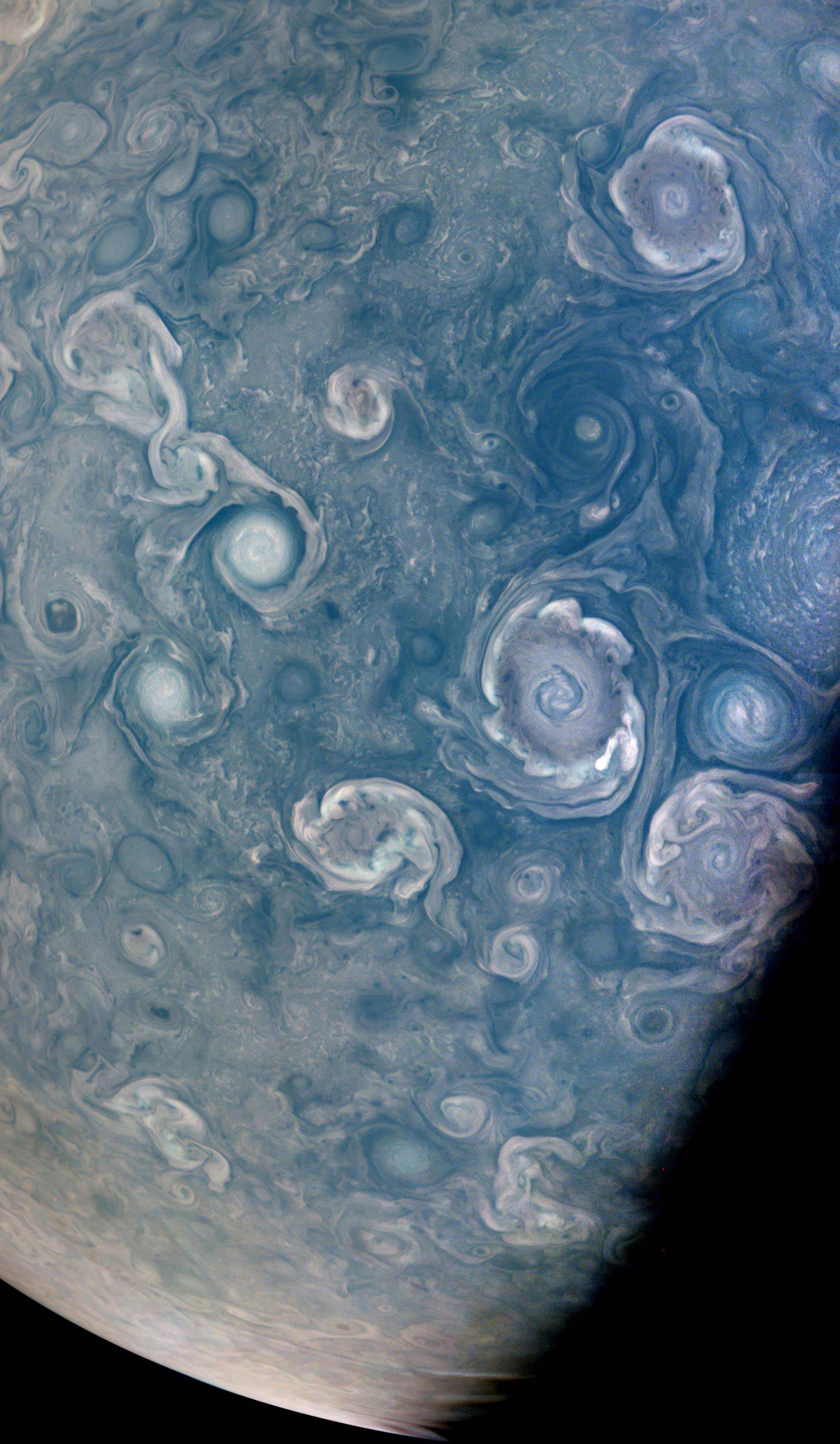 NASA&#39;s JunoCam captured this dazzling view near Jupiter&#39;s north pole on July 5. The spiral shaped vortices are wind patterns from storms.