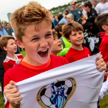 A Junior Soccer League player cheers when NJ/NY is selected as a host city for the 2026 World Cup.