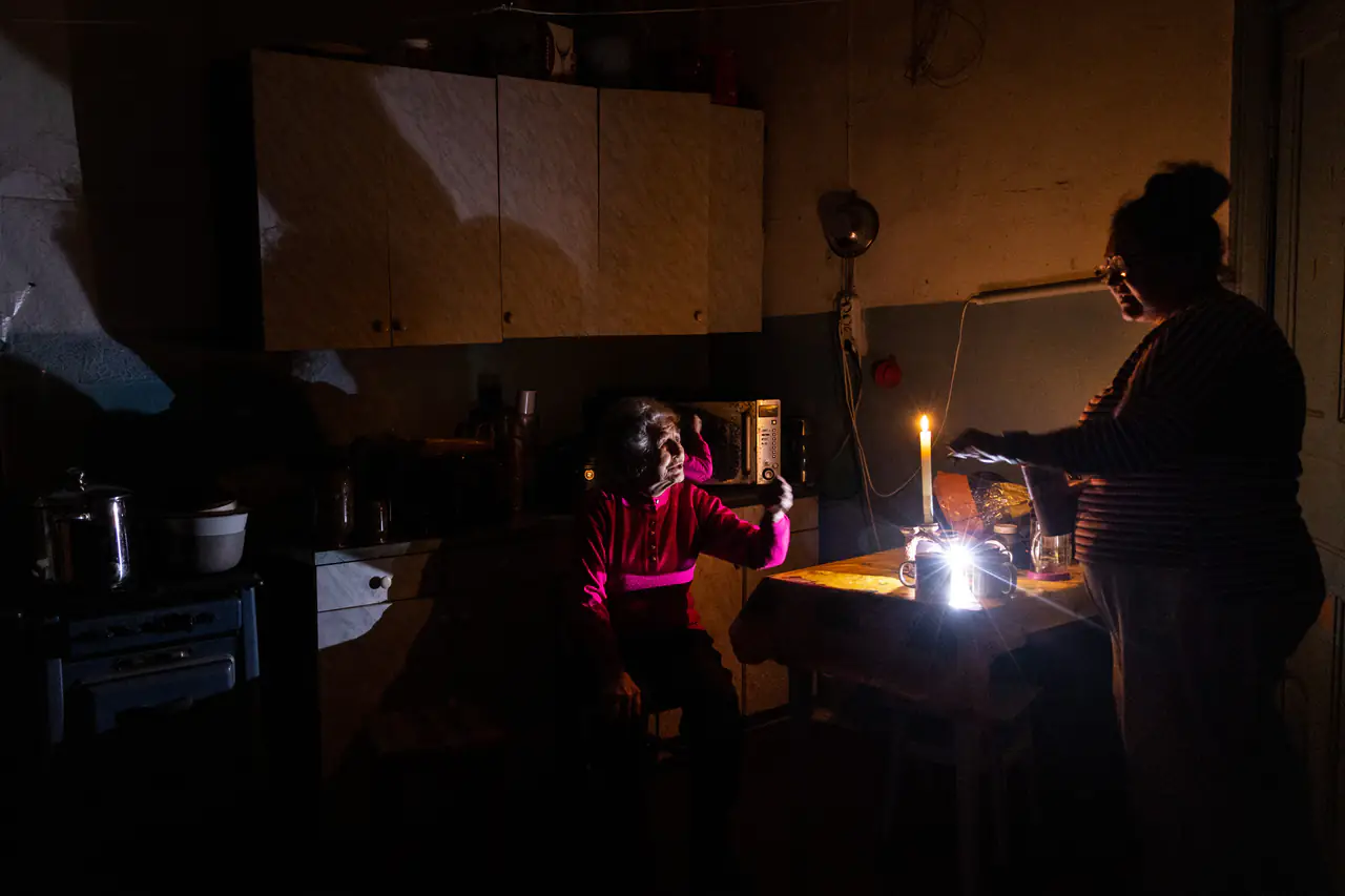 Natalia Zemko, left, talks with her daughter Lesya Zemko in their kitchen during a power cut in Kyiv in October.