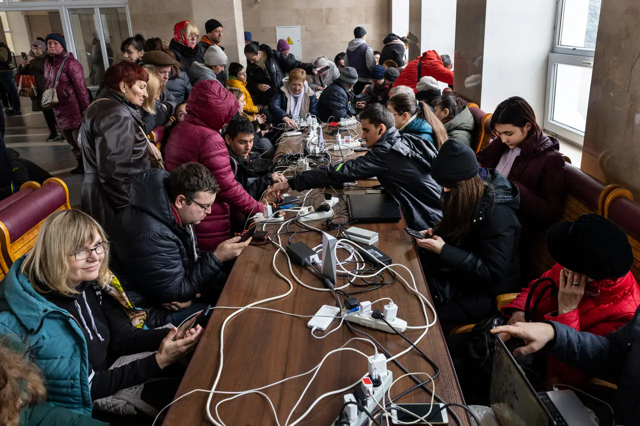 Residents charge their computers and phones in November at a train station in Kherson, Ukraine, after the city was liberated.