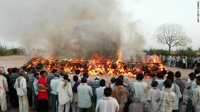 Indians pay last respects at a mass cremation of 15 school girls at the banks of the river Orsang in Bamroli on April 16, 2008.